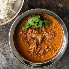 lentils in copper bowl with melted butter and cilantro on top