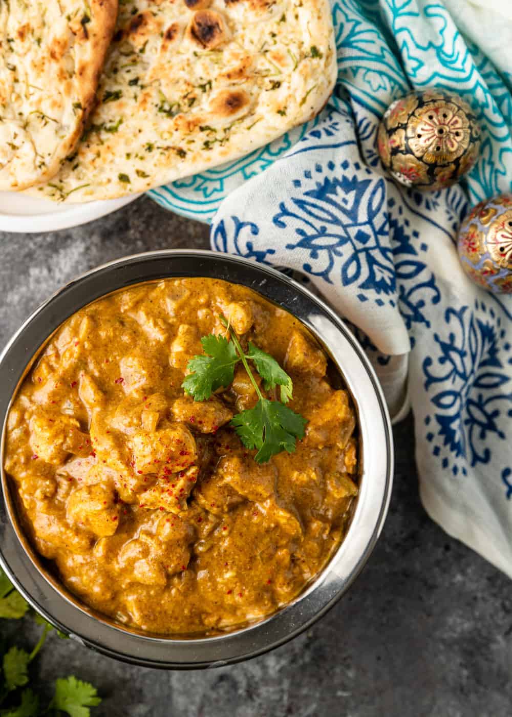 creamy Indian curry in serving bowl, garnished with cilantro