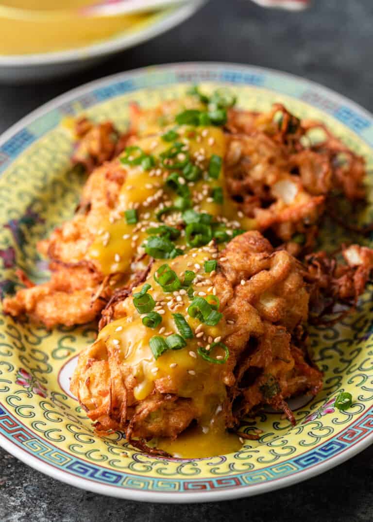 chicken egg foo young on platter with scallion and sesame seeds