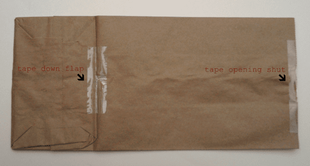 brown paper bag with taped down flap and opening taped