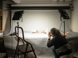 Female student photgraphing architectural models