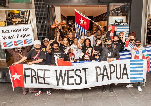 A group of people holding a banner