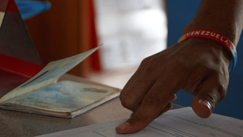 National filling out an applications with his passport