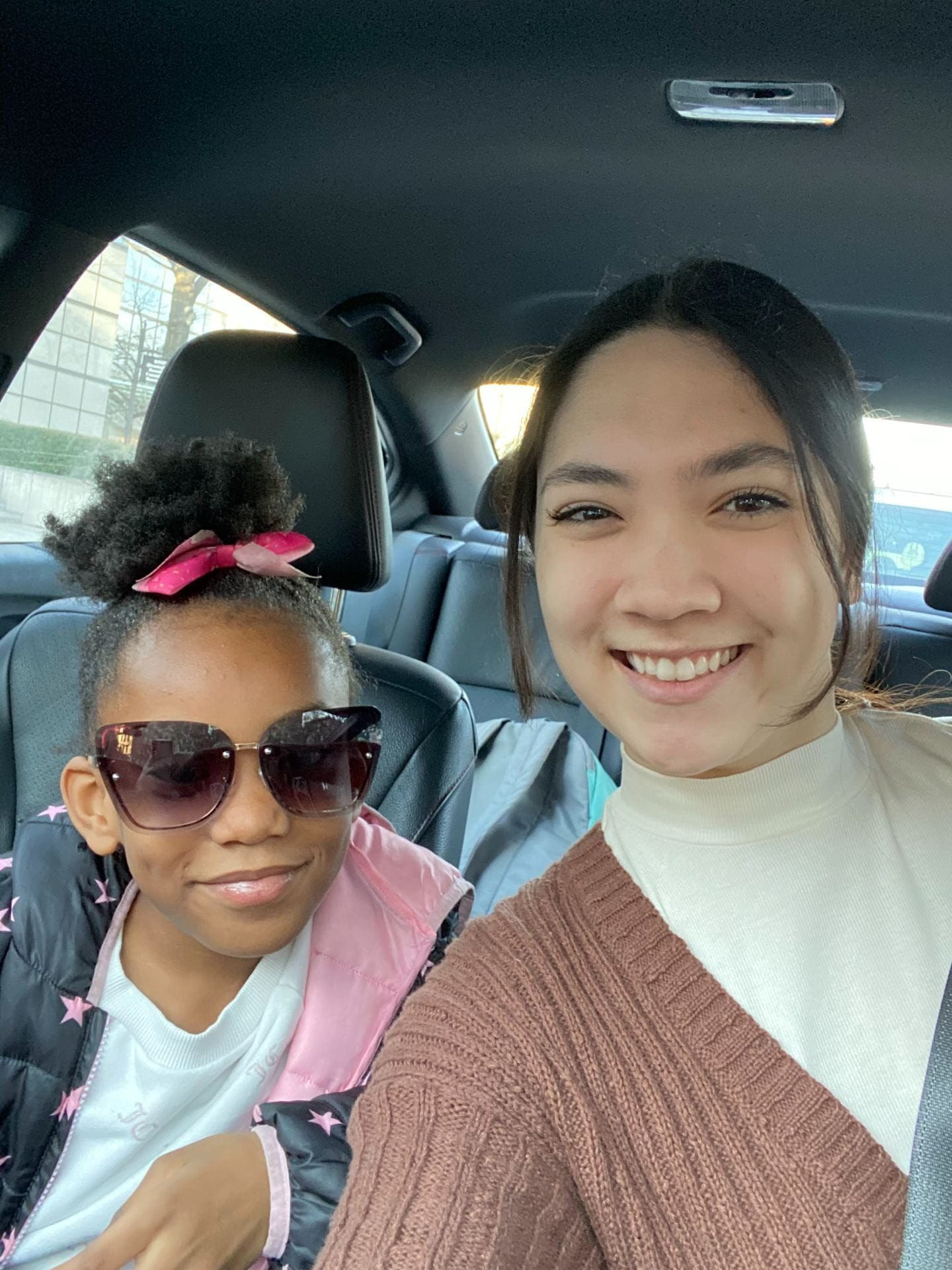 In this picture, Shae and I are sitting in my car and she asked me to take a picture of her trying on my sunglasses.