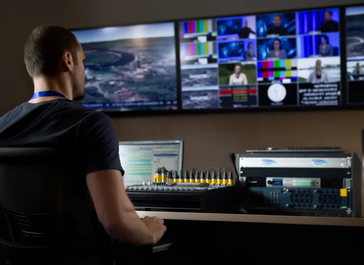 A broadcast engineer operates, monitors and adjusts the controls at a sound board and other equipment used in radio and TV