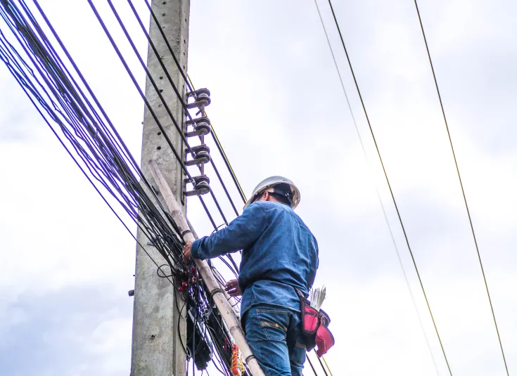 A fiber optics technician connects a network