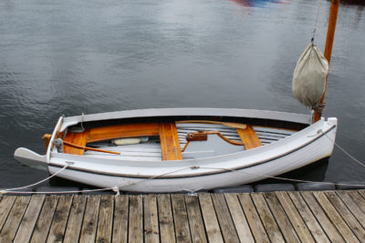 This spritsail boat isn't yet equipped with oarlocks. The original had rowing stations at the center and forward thwarts with oarlocks mounted on blocks fixed to the outside of the coaming