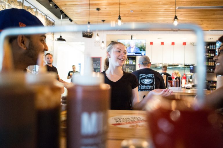 Sonny's server laughing with customers