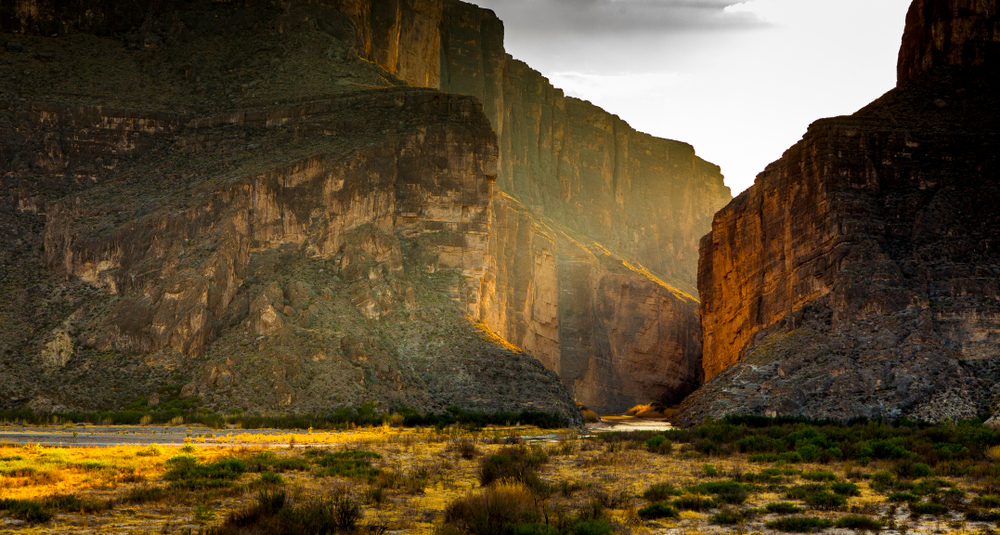 large mountains in a valley at sunset