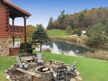 a cabin. on the pond featuring firepit and hottub