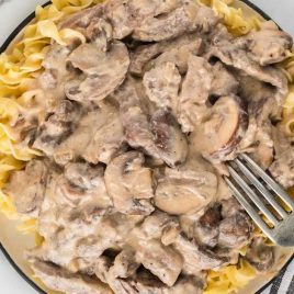 close up overhead shot of a bowl of Beef Stroganoff with a fork