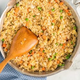 close up overhead shot of better than take-out fried rice in a pan with a wooden spoon