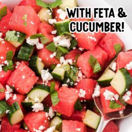 close up overhead shot of a serving of watermelon salad topped with mint leaves and feta cheese in a bowl