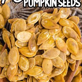 close up shot of a bunch of Roasted Pumpkin Seeds on a wooden spoon