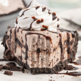 A piece of chocolate cake on a plate, with Cream