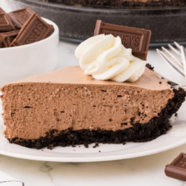 A slice of Hershey Pie on a white plate next to forks.