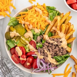 a burger bowl drizzled with sauce