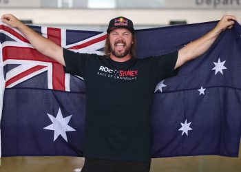 Toby Price draped in an Austalian flag.