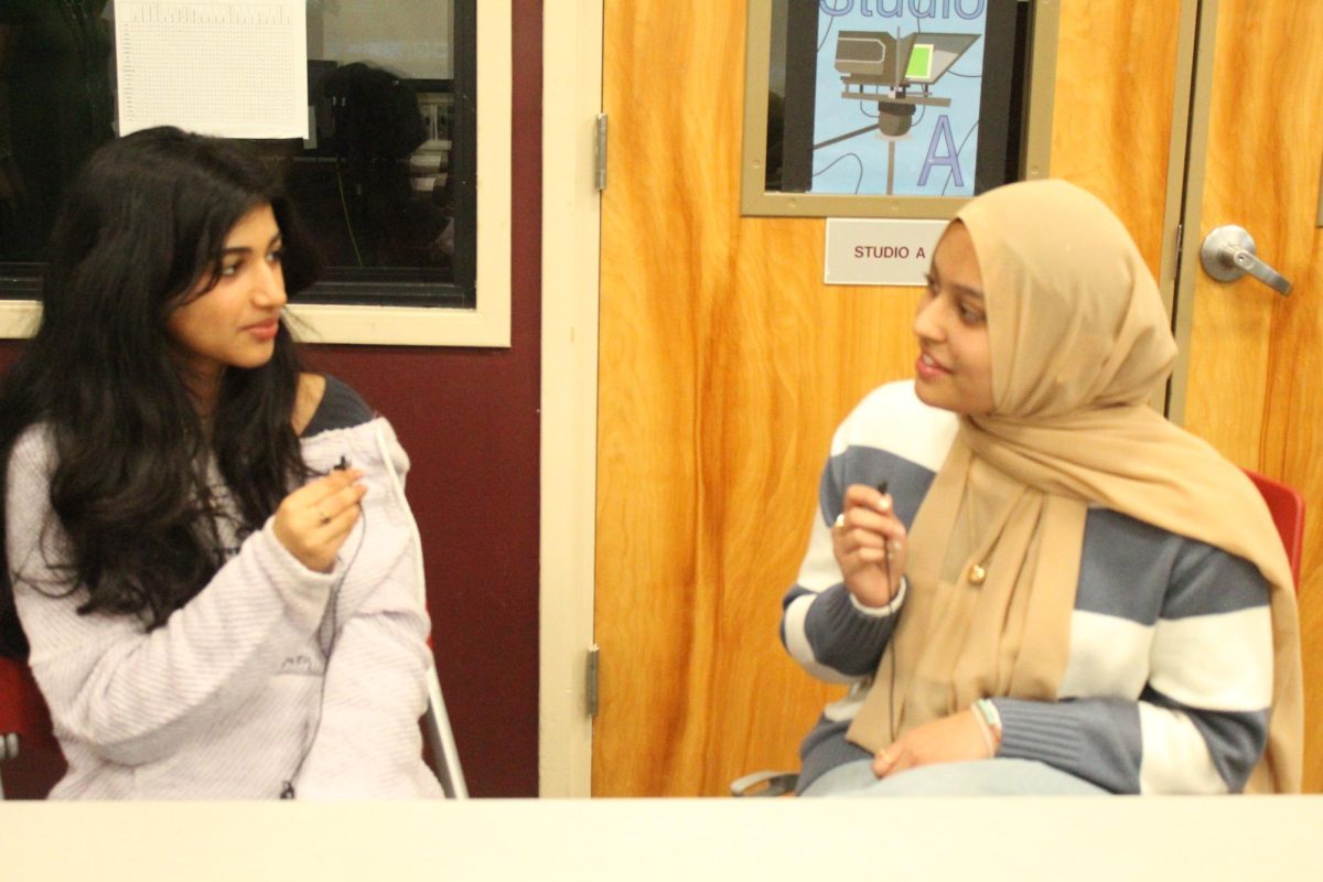 Pro podcasters: Juniors Arohi Nepal (left) and Zaina Sohail (right) record an episode of their podcast, “Rights and Realities.” They started the podcast as a way to discuss global human rights issues. 