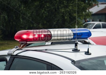 A Close Up Of A Swithched Rotating Beacon Of A Police Car. Cop Car Rooftop Flashing Lights Outdoors.