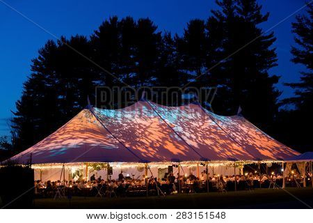 Wedding tent at night - Special event tent lit up from the inside with dark blue night time sky and