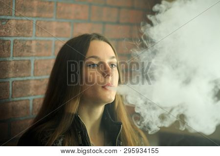 Vape Teenager With  Problem Skin. Portrait Of Young Cute Girl In Sunglasses Smoking An Electronic Ci