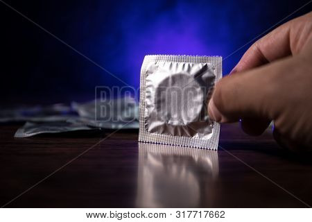 Close Up Of A Young Beautiful Girl Holding An Open Female Condom, Safe Sex Concept. Protection Again