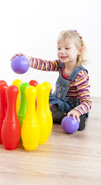 Little girl playing with skittles Stock Photo by ©phb.cz 45849387