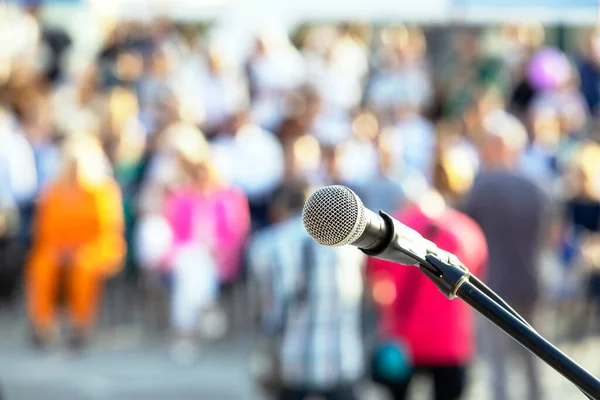 Publicity or media event, microphone in the focus against blurred ...