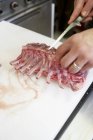 Chef Trimming rack of lamb — Stock Photo