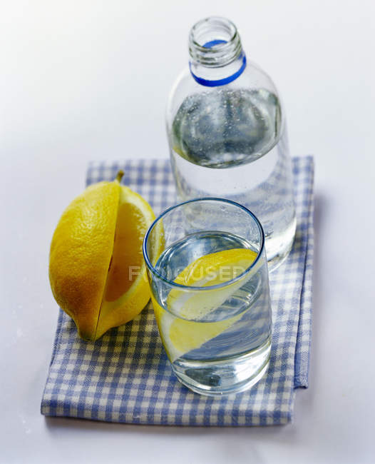 Bottle and glass of mineral water — Stock Photo