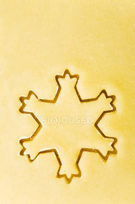 Closeup top view of cut-out snowflake biscuit — Stock Photo