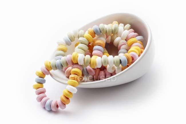 Closeup view of candy bracelets in white bowl — Stock Photo