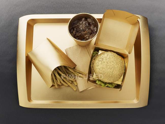 Top view of fast food with a gold colored disposable food set — Stock Photo