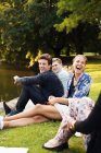 Happy friends enjoying at riverbank — Stock Photo