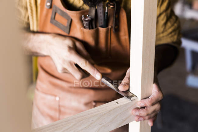 Carpenters hands using chisel in workshop — Stock Photo