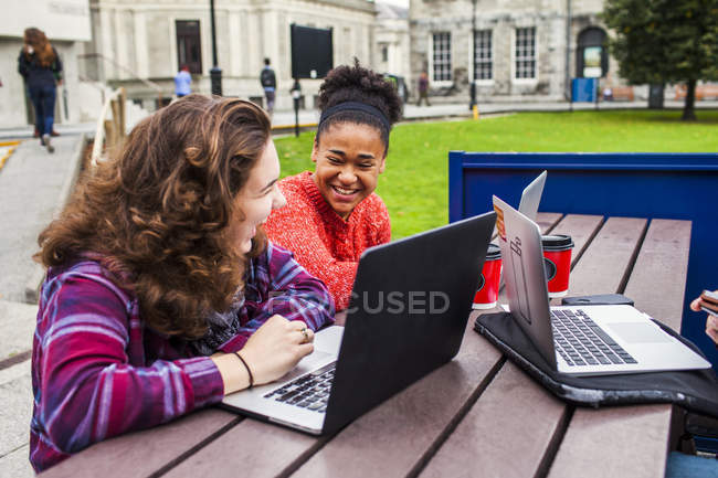 Cheerful female university students — Stock Photo