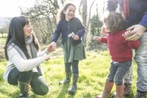 Mother and father with children in garden — Stock Photo