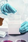 Microbiology technician working with bacteria strains in plastic box. — Stock Photo