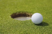 Golf Ball Near Hole — Stock Photo