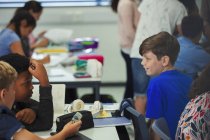 Junior high school students talking in classroom — Stock Photo