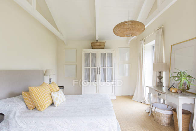 Bed and cabinet in bedroom of rustic house — Stock Photo