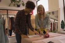 Fashion designers working on fabric in fashion studio — Stock Photo