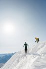 Male and female skiers skiing on a snowy mountain during winter — Stock Photo