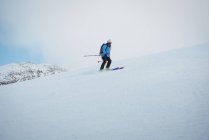 Skier skiing on snow covered mountains — Stock Photo