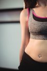 Midsection of pole dancer leaning against pole in fitness studio — Stock Photo