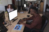 Male executive working at desk in office — Stock Photo