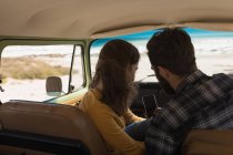 Couple using mobile phone in vehicle on road trip — Stock Photo