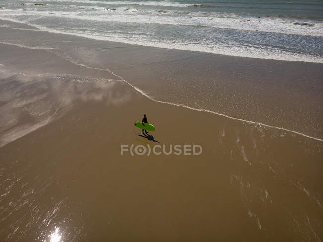 High angle view of Surfer with surfboard walking on the beach — Stock Photo