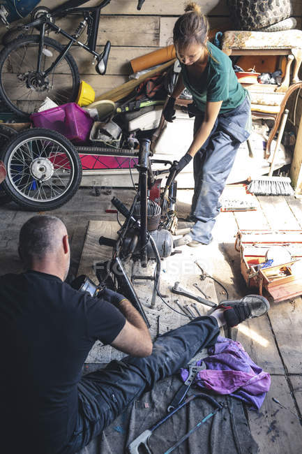 High angle view of mechanic repairing motorbike in garage — Stock Photo